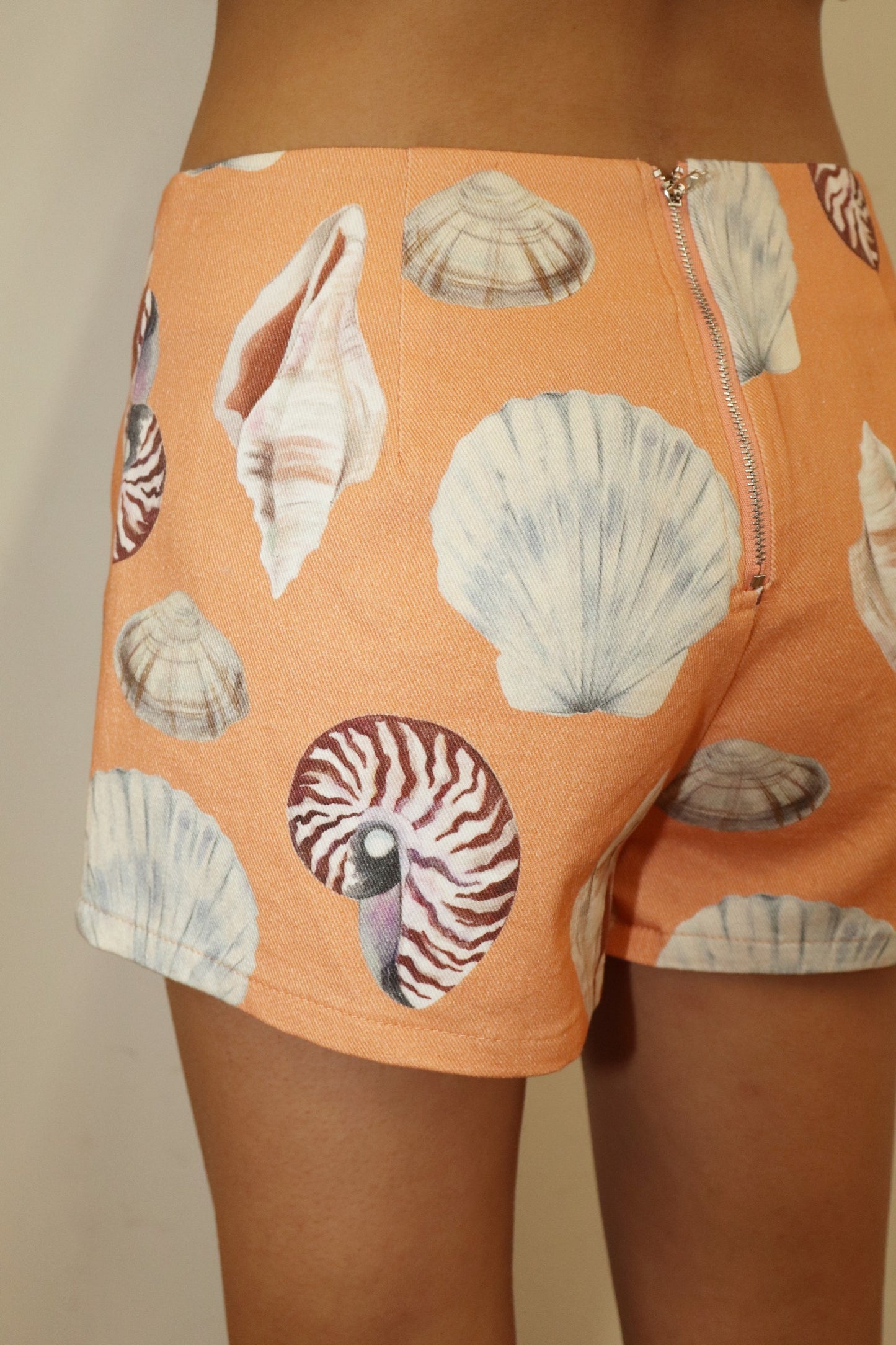 Orange Seashell print shorts